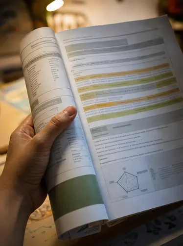Parent holding a highlighted report excerpt under warm light