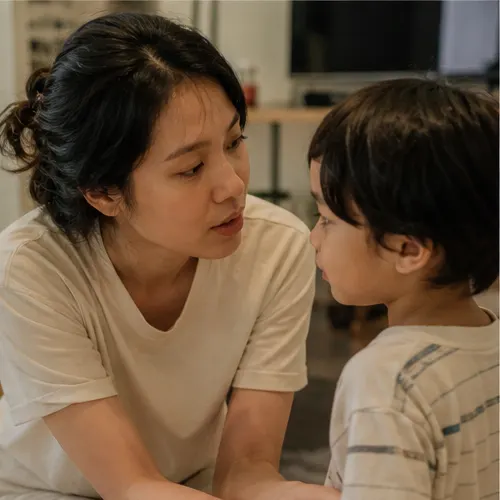 Parent communicating gently at child eye level